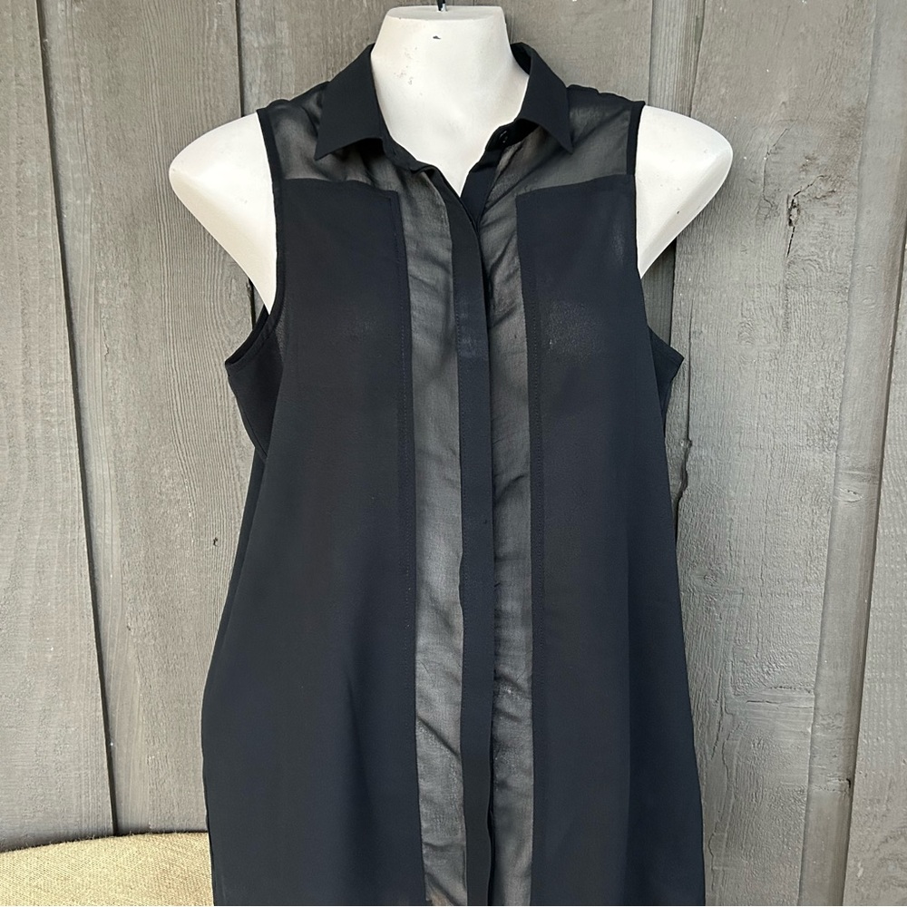 Black top sleeveless with sheer insets collar and hidden buttons
